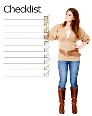 Woman in casual attire with checklist, marking items, representing a sump pump selection guide for homeowners.