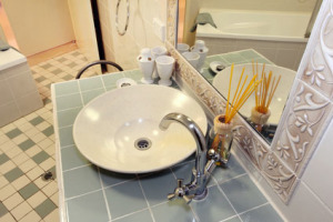 Bathroom sink with modern bowl design, faucet, and decorative elements, emphasizing plumbing setup for effective water flow and spigot sealing in remodeling context.