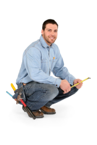 Plumber squatting with tools, showcasing expertise in plumbing services for garbage disposal odor issues.