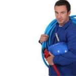 Plumber holding plumbing tools and equipment, emphasizing professional service for gas line installation and safety in residential plumbing.