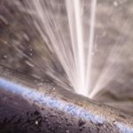 Water gushing from a broken pipe, illustrating a plumbing emergency related to sewage backup.
