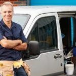 Professional plumber standing confidently next to service van, showcasing expertise and readiness for emergency plumbing services in Falls Church, VA.